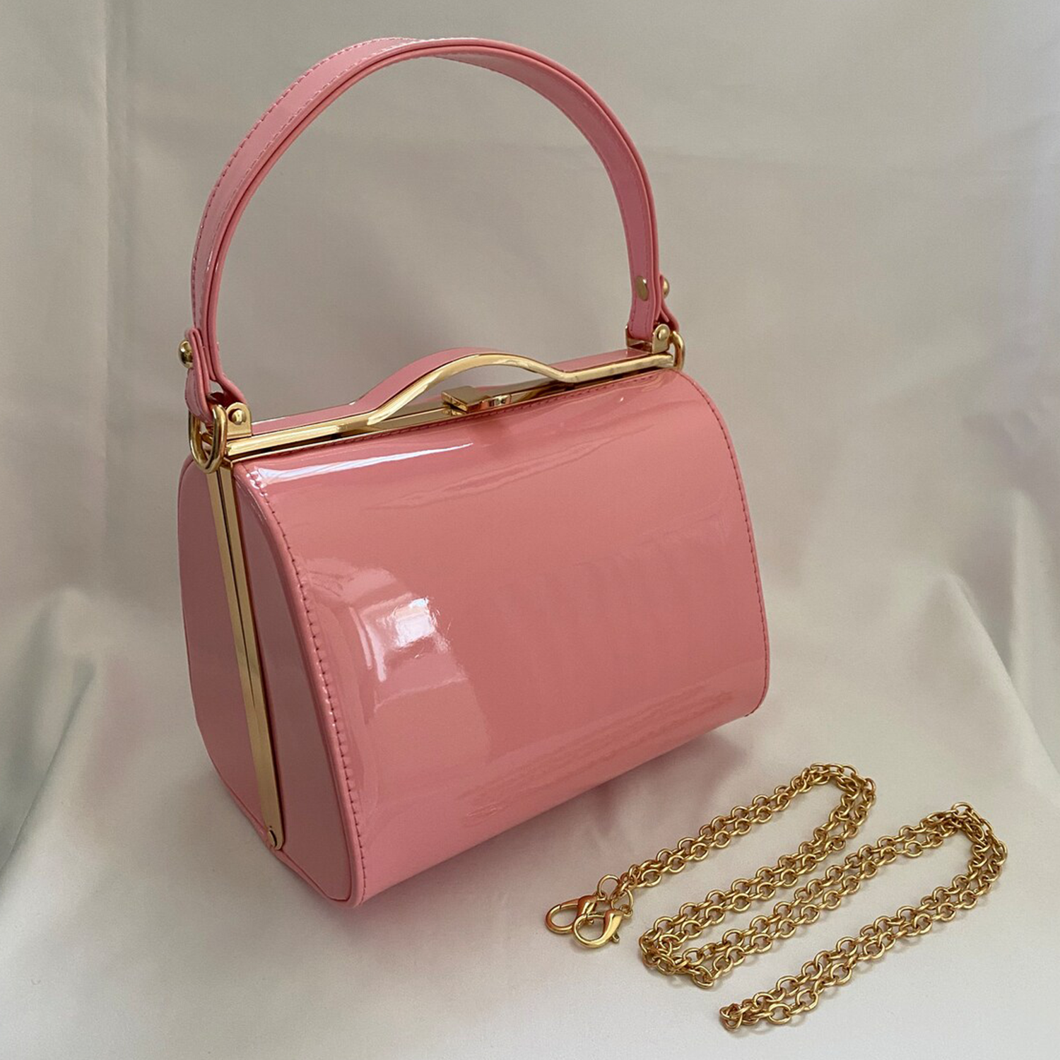 Soft Carnation Pink High-Gloss Patent Curved Rectangular Vintage Box Handbag With Wavy Gold Top Clasp Frame, Fixed Curved Top Handle And Detachable Polished Link Chain Hardware