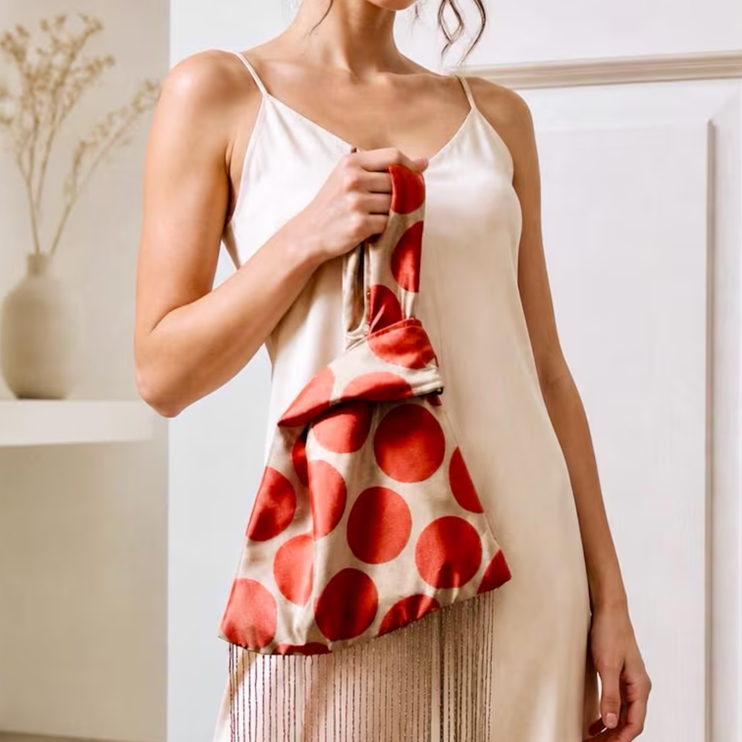 Pale Neutral Coral Polka Dot Lustrous Fabric Knot Wrist Pouch With Full-Length Shimmer Crystal Fringe Hem Detail
