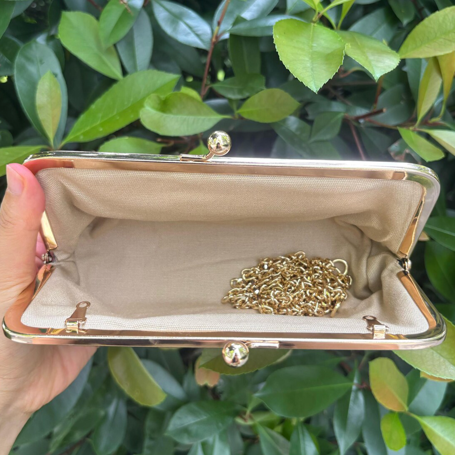 Matte Jet Black Soft Pebbled Grain Elongated Kiss-Lock Clutch With Polished Gold Metal Frame, Spherical Dual Ball Clasp And Detachable Link Chain Shoulder Strap Hardware