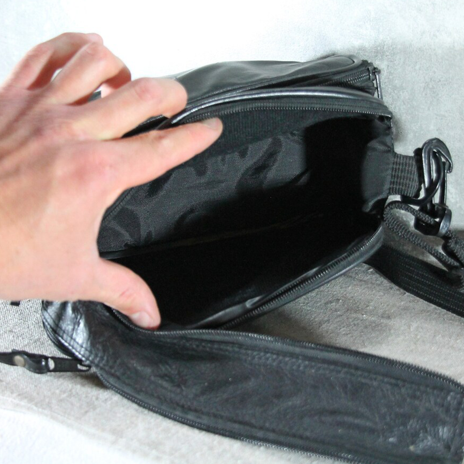 Matte Jet Black Naturally Wrinkled Grain Compact Rectangular Gear Pouch With Dual Stacked Front Zip Compartments And Woven Fabric Clasp Mount Strap Hardware Camera Bag