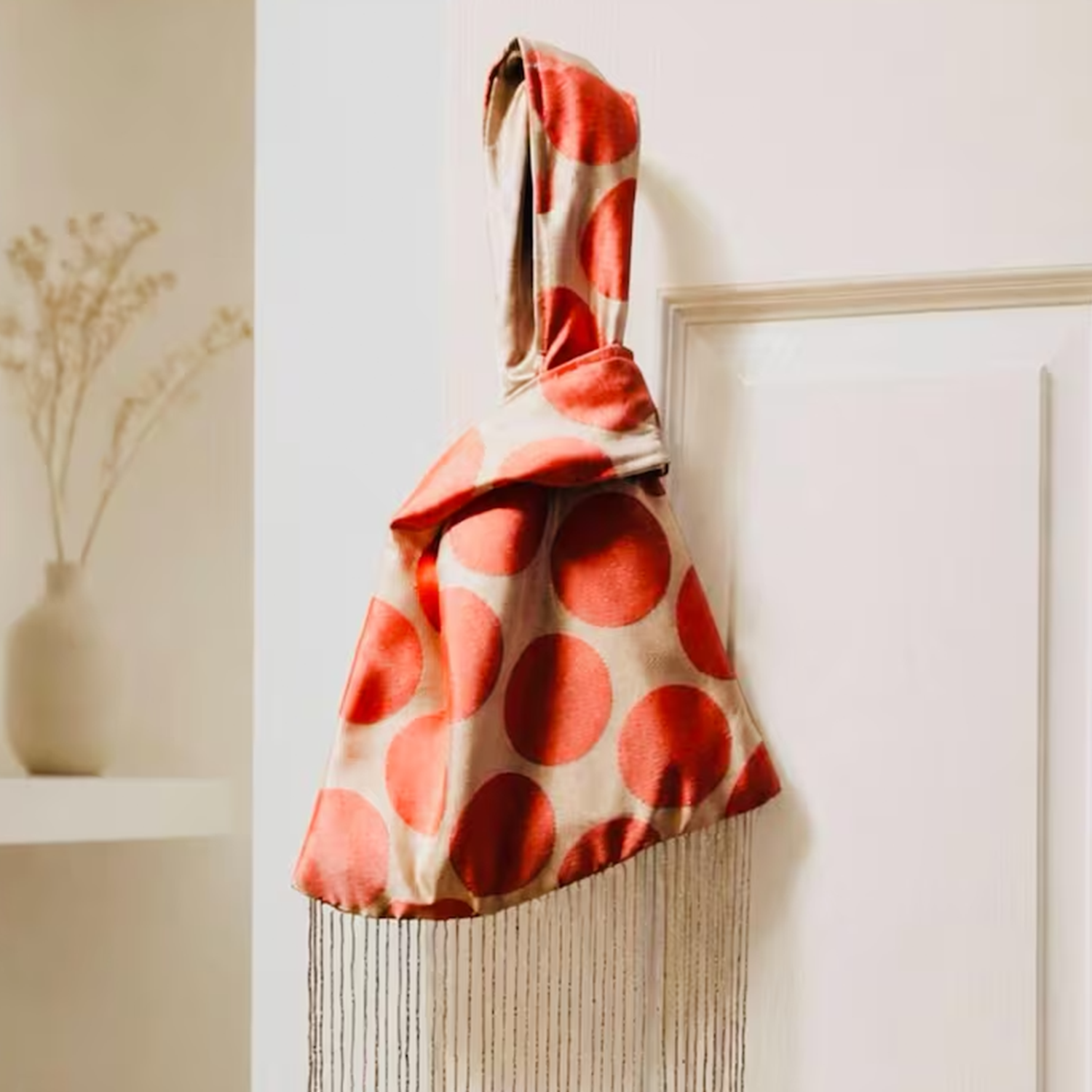 Pale Neutral Coral Polka Dot Lustrous Fabric Knot Wrist Pouch With Full-Length Shimmer Crystal Fringe Hem Detail